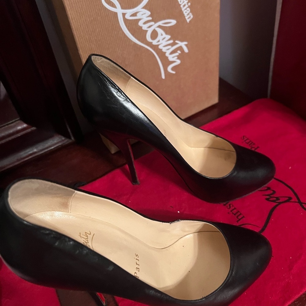 One pair of Christian Louboutin, either the black ones or the tan ones 250